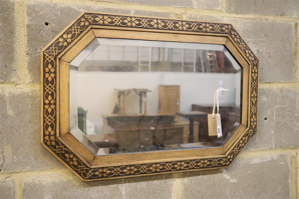 A circular convex wall mirror and an octagonal oak framed wall mirror, larger 70cm wide